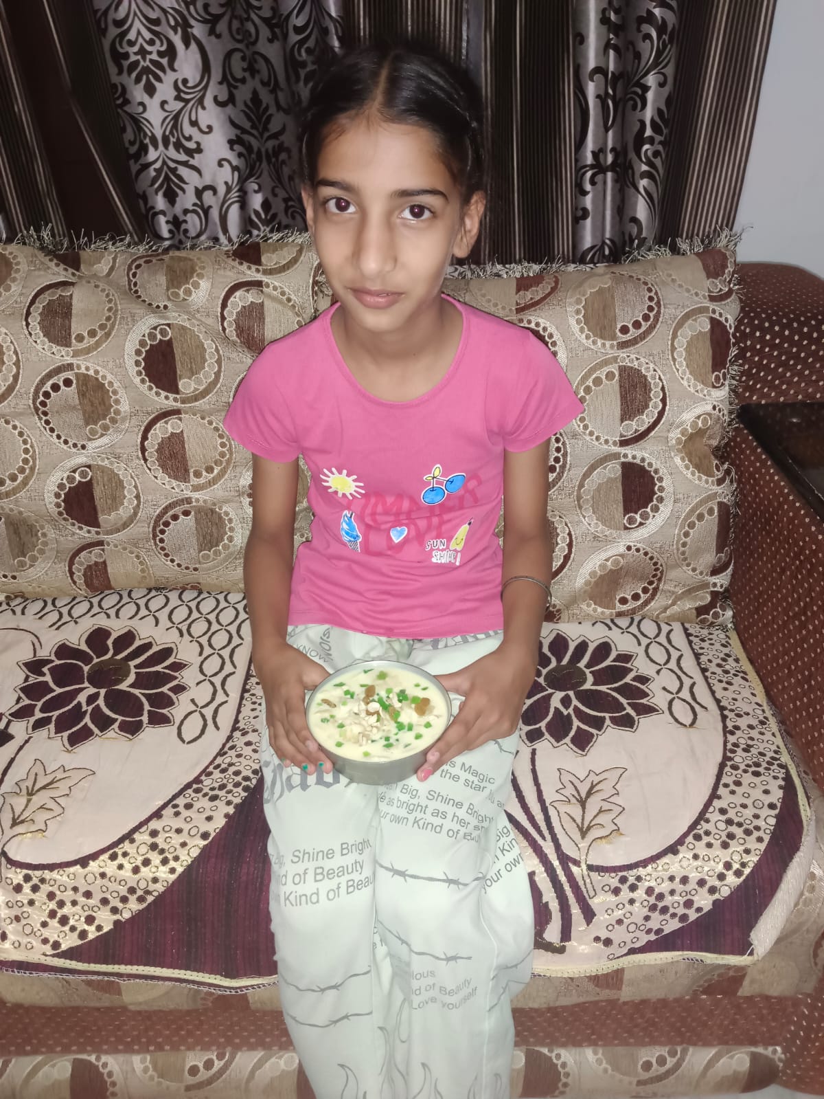 Student holding the delicious Fruit Custard